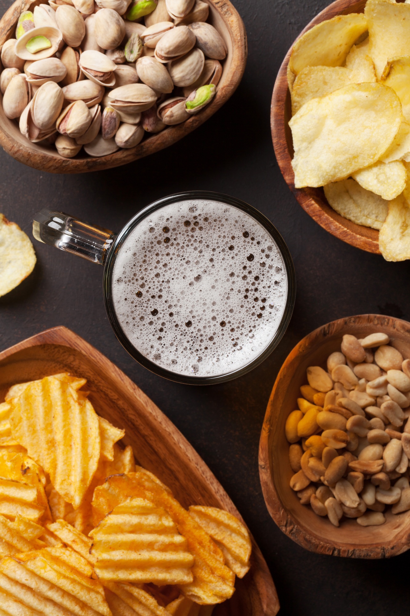 lager beer and snacks on stone table
